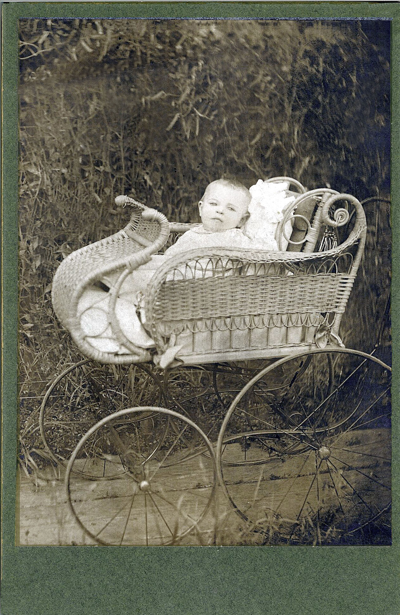 Photo of Frances Josephine Kirkland as a baby in her wicker carriage.